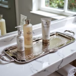Luxury silver rectangular tray holding premium skincare products on bathroom vanity