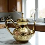Steaming gold brass teapot hand-engraved with gooseneck spout in a modern kitchen environment