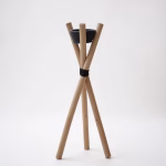 Minimalist wooden tripod outdoor candle holder with black ceramic bowl on white studio background