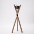 Minimalist wooden tripod outdoor candle holder with black ceramic bowl on white studio background