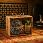 Handcrafted Moroccan gift box with tea glass, ceramic plate, and mint leaf