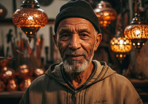 Master Moroccan copper lamp artisan Abdul Jalil in his Marrakesh workshop, portrait.