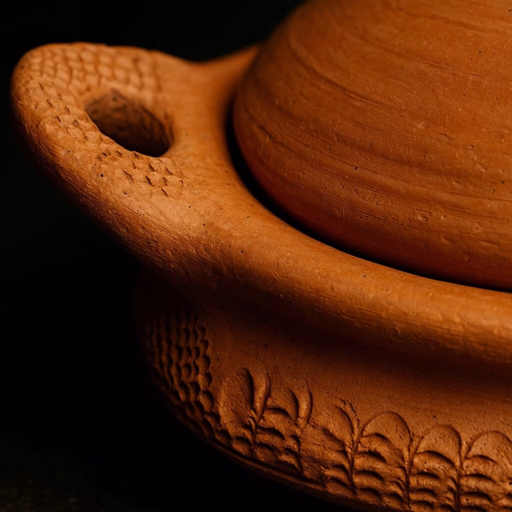 Close-up of textured handle on handmade terracotta tagine pottery lid.