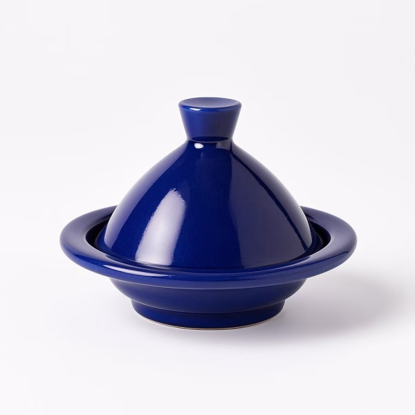 Deep cobalt-blue ceramic mini tagine with smooth glossy surface, isolated on a white background.