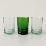 Lineup of three 4 oz Moroccan drinking glasses—clear, emerald, and clear—against white.