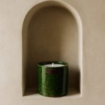 Deep green Tamegroute ceramic candle displayed in arched niche alcove with leather detail tag