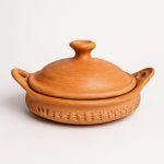 Studio shot of lidded 12 Marrakech tagine pottery against white background.