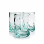 Studio shot of three wavy Moroccan recycled glass cups against a white background.