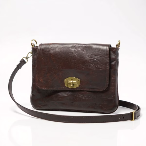 Premium leather crossbody bag front view showing brass turn-lock closure and adjustable strap