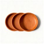 Handmade terracotta ceramic plates set of three with natural clay texture and warm rust-orange finish
