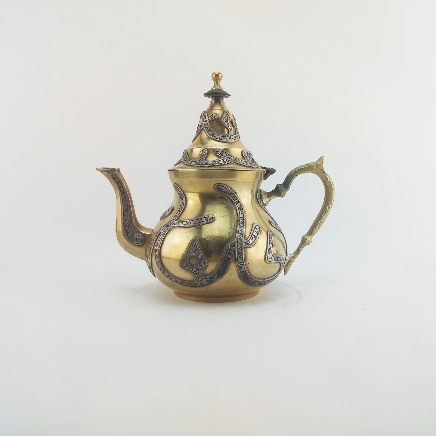 Authentic 1910 Moroccan Brass Teapot with Arabic Calligraphy 1910 antique Moroccan brass teapot with hand-embossed Arabic calligraphy featured image