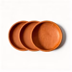 Three natural terracotta earthen plates arranged showing set of handmade Moroccan pottery