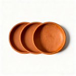 Three natural terracotta earthen plates arranged showing set of handmade Moroccan pottery