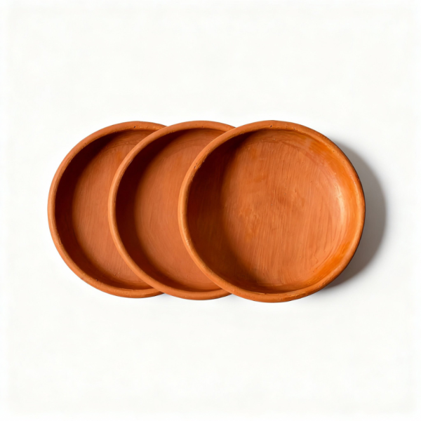 Three natural terracotta earthen plates arranged showing set of handmade Moroccan pottery