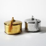 Set of two decorative metal boxes with lids - one brass gold and one silver with tassels