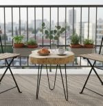 Live edge coffee table on modern apartment balcony with breakfast setting and herb plants