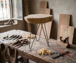 Artisan woodworking tools and wood shavings showing handcrafted furniture making process
