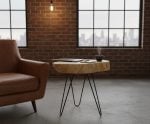 Organic wood coffee table in industrial loft apartment with exposed brick and city windows