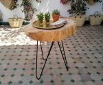Handcrafted wood coffee table on Moroccan patio with zellige tiles and woven straw baskets