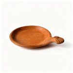 Side view of terracotta serving dish showing shallow depth and extended handle design