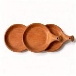Set of three terracotta serving dishes with handles arranged together showing matching handmade design