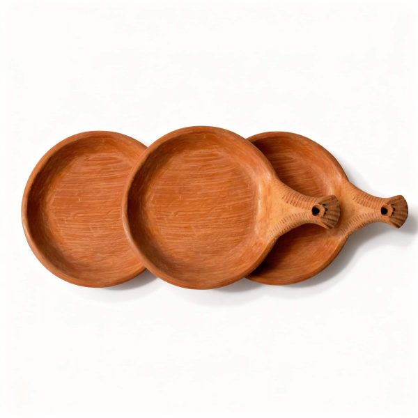 Set of three terracotta serving dishes with handles arranged together showing matching handmade design