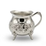 Hand-engraved silver mini creamer pitcher with geometric arabesque patterns and decorative tripod feet