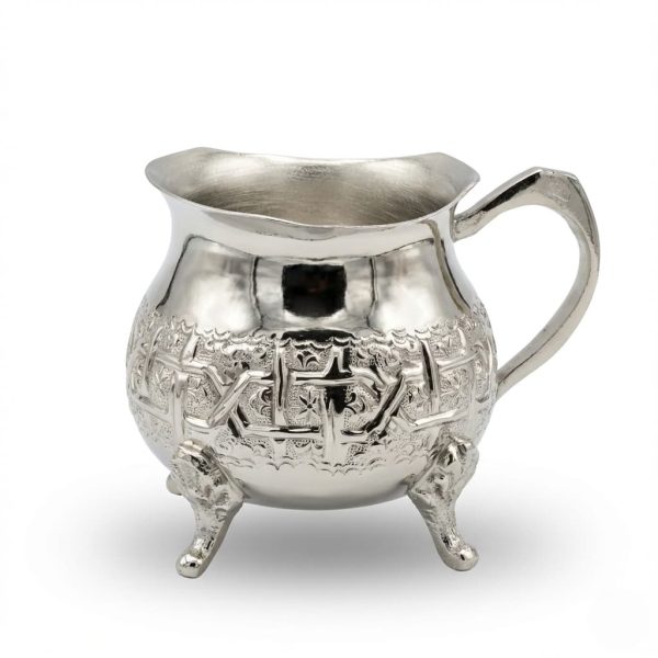Hand-engraved silver mini creamer pitcher with geometric arabesque patterns and decorative tripod feet