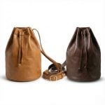 Leather bucket bags in tan and dark brown with adjustable crossbody straps