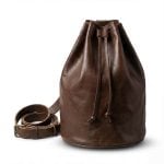 Dark brown leather bucket bag front view with coiled adjustable strap