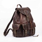 Side angle view of handcrafted leather rucksack with buckle details