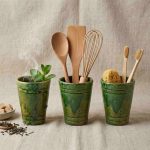 Three green ceramic mugs showing different uses as tea cup utensil holder and bathroom organizer