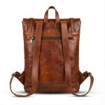 Leather backpack back view showing padded straps and security zipper pocket