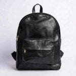 Minimalist leather backpack in black with front pocket and antique brass zippers, handmade from genuine Moroccan leather