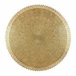 Close-up of hand-engraved brass filigree wall lamp showing arabesque floral patterns and scalloped decorative edge