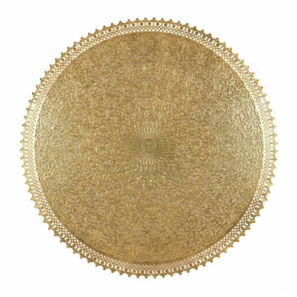 Close-up of hand-engraved brass filigree wall lamp showing arabesque floral patterns and scalloped decorative edge