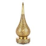 Teardrop brass table lamp with hand-engraved filigree floral patterns on decorative perforated base against white background