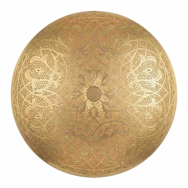 Round brass wall sconce with hand-pierced arabesque and floral medallion pattern illuminated showing warm golden glow on white background