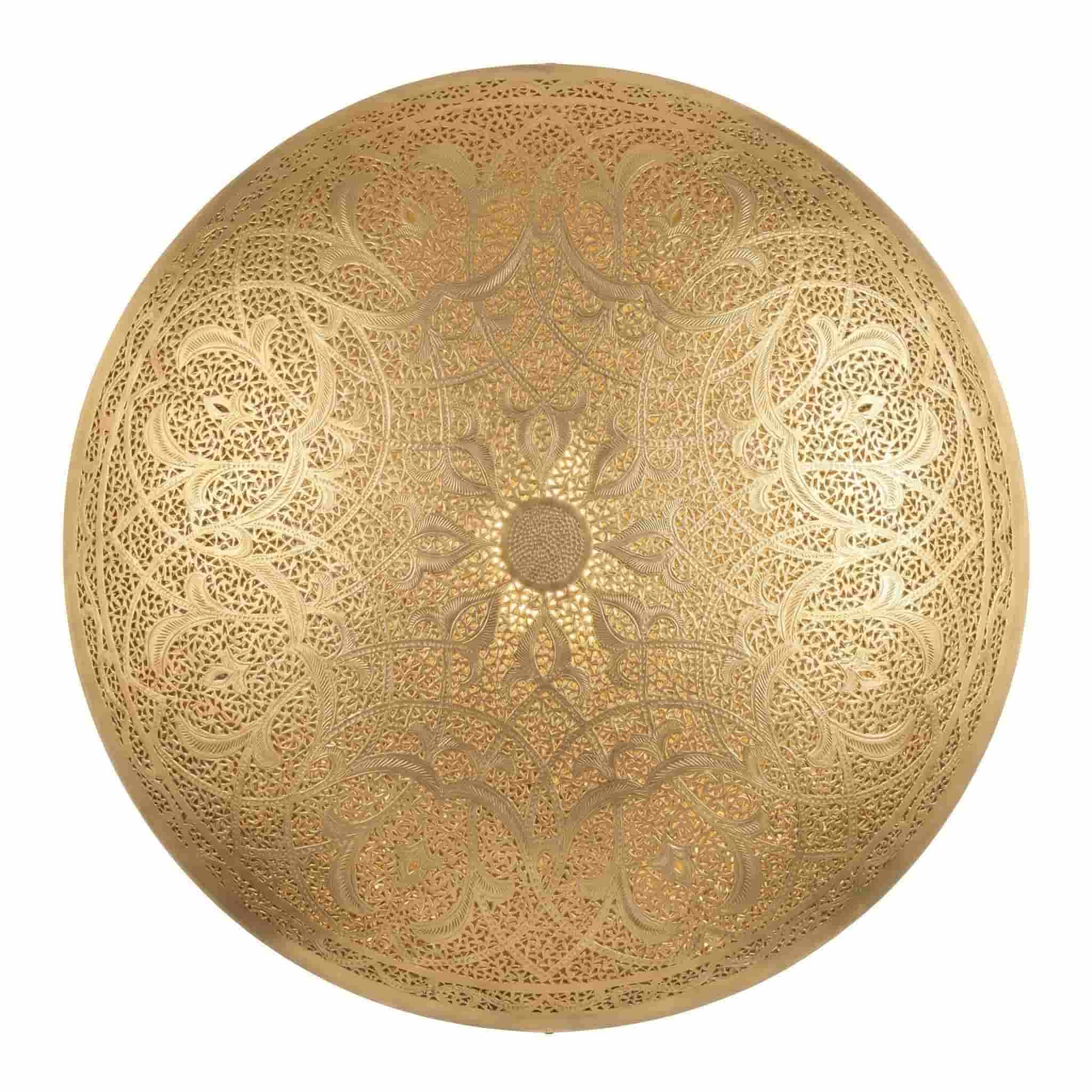 Brass Wall Sconce (1) Round brass wall sconce with hand-pierced arabesque and floral medallion pattern illuminated showing warm golden glow on white background