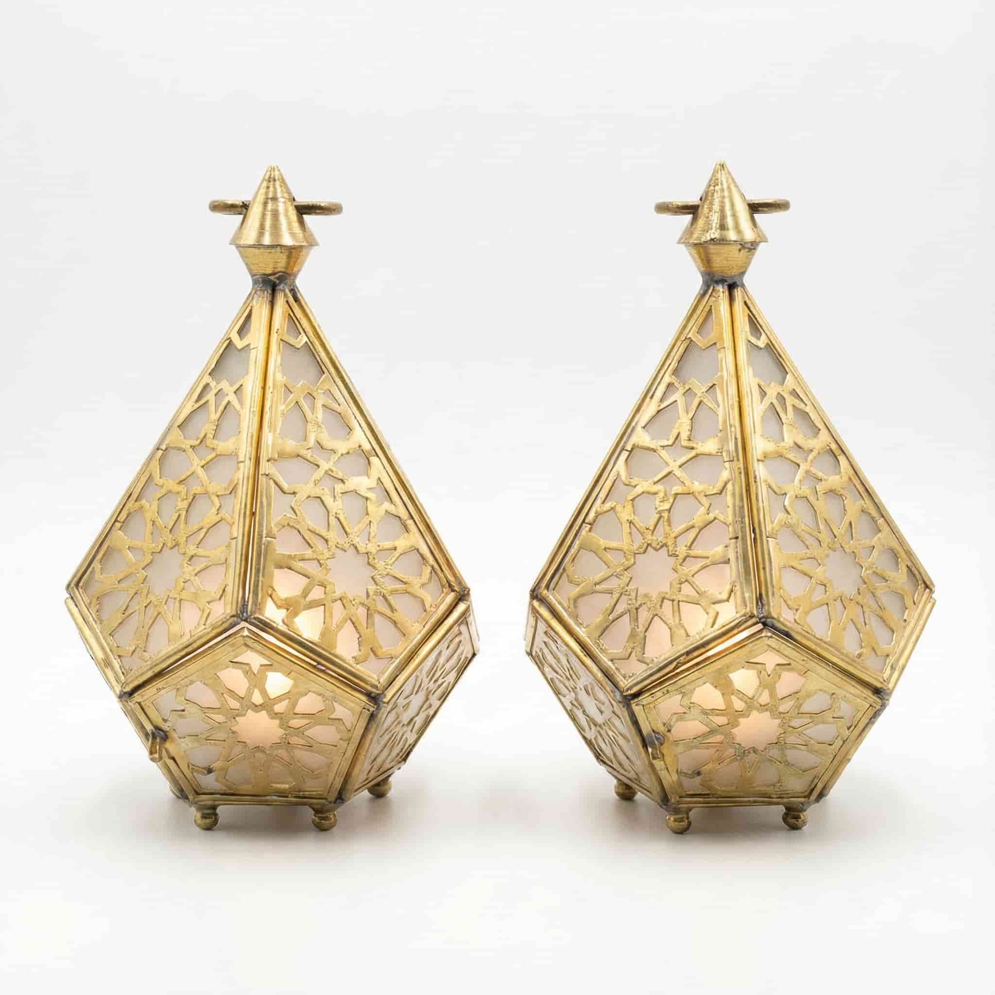 Geometric Brass Candle Lantern (1) Pair of geometric brass candle lanterns with Islamic star patterns and frosted glass panels on white background