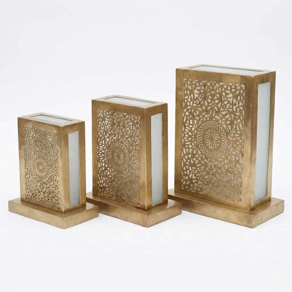 Three brass lantern table lamps in small medium and large sizes with hand-pierced front panels and frosted glass sides