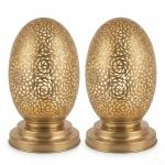 Set of two brass oval table lamps featuring hand-engraved spiral patterns on polished round bases