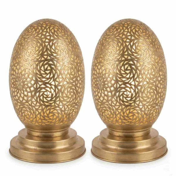 Set of two brass oval table lamps featuring hand-engraved spiral patterns on polished round bases