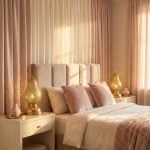 Brass pear table lamps as romantic bedside lighting in blush pink bedroom creating warm ambient glow