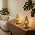 Brass pear table lamps on modern credenza in minimalist living room projecting intricate light patterns