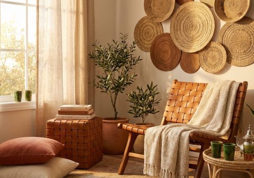 Complete Moroccan-inspired reading and tea nook featuring woven leather furniture, artisan ceramics, and natural textures in warm natural light