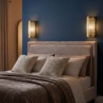 Moroccan filigree wall lights mounted either side of bed headboard on deep blue feature wall