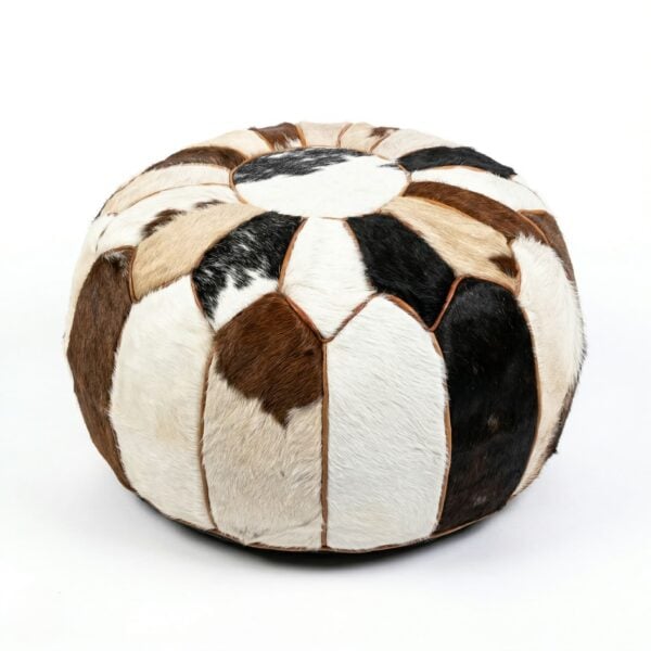 andcrafted cowhide round pouf with natural brown black and white hair-on-hide patchwork panels on white background