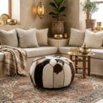 Cowhide patchwork pouf in Moroccan living room with brass pendant lantern tea set and neutral sofa