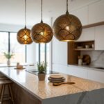 Three Moroccan brass pendant lights over a marble kitchen island casting dotted light patterns